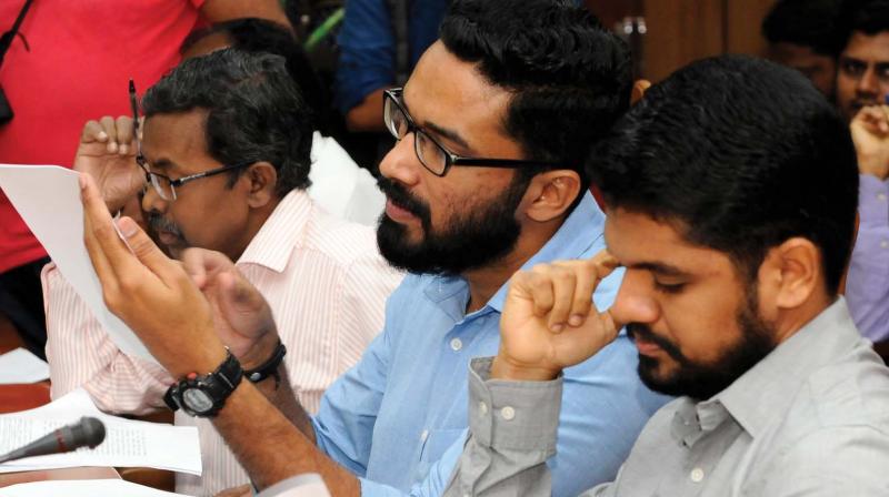 Idukki collector G. R. Gokul and Devikulam sub-collector Sriram Venkitaraman  engrossed in checking official papers at the meeting convened by the Chief Minister  to discuss Munnar land encroachment issue, in Thiruvananthapuram on Saturday. (Photo: DC)
