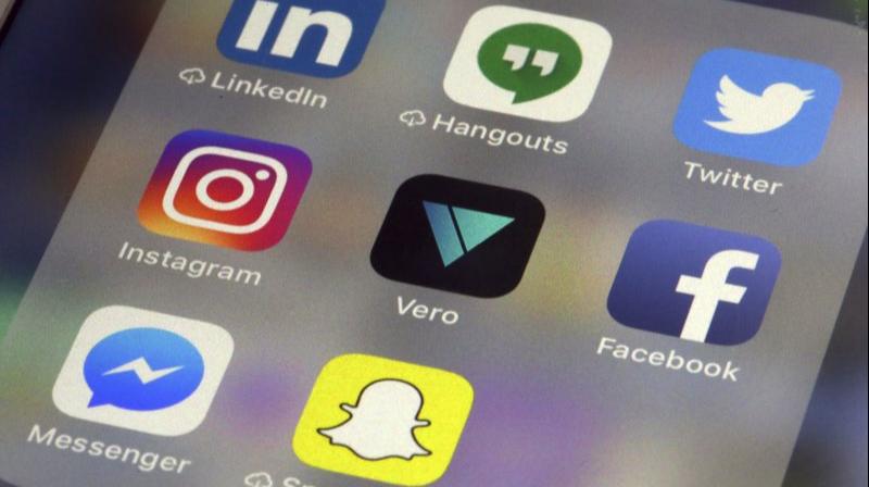 Vero app, center, is displayed on an iPhone in New York. (AP Photo/Richard Drew)