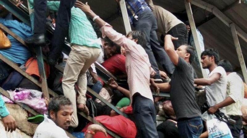 At least 22 people were killed and several injured in a rush hour stampede on a foot overbridge linking Elphinstone Road and Parel suburban stations in Mumbai on Friday morning. (Photo: PTI)