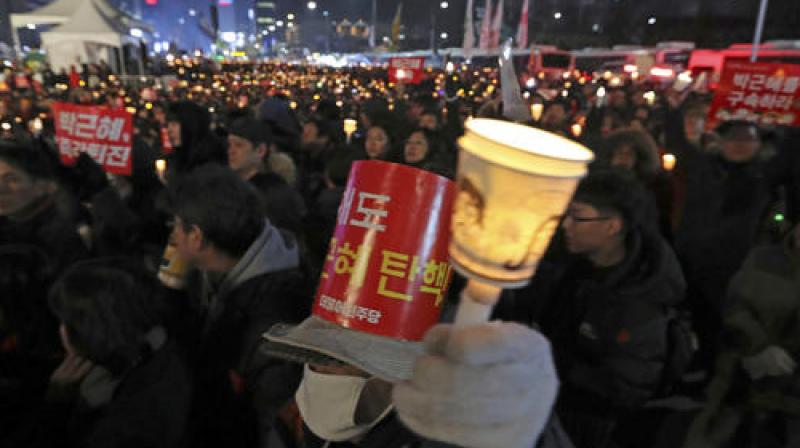 Candle-carrying and banner-waving protestors marched towards key buildings in Seoul including the presidential Blue House and the prime ministers office. (Photo: AP)