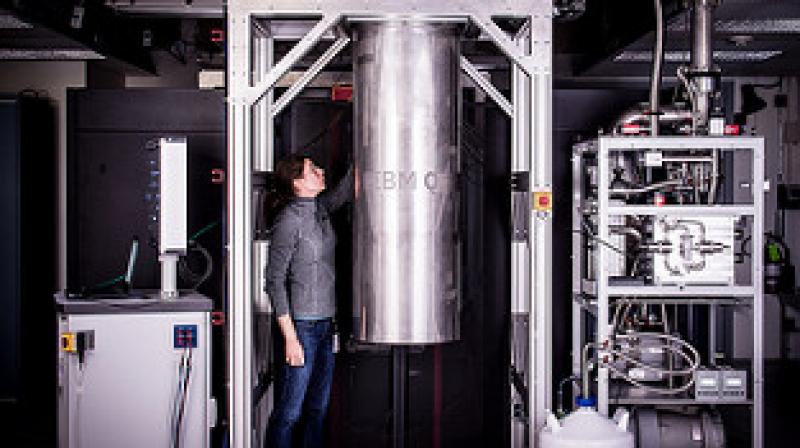 IBM Research Staff Member Katie Pooley, an Applied Physics PhD from Harvard who joined IBM in 2015, at the Thomas J Watson Research Center, is a process integrator on the IBM Q team. In the photo, Pooley is examining a cryostat with the new prototype of a commercial quantum processor inside. (Credit: Andy Aaron, IBM)