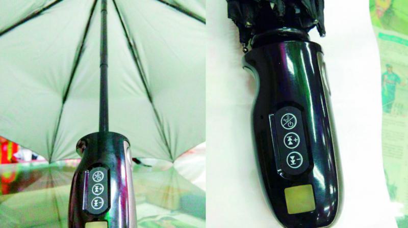 The umbrella (Left) and its handle displaying various functions.