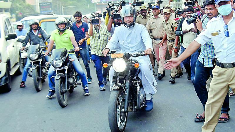 MIM president Asaduddin Owaisi arrives at Pragathi Bhavan on his motorbike on Monday.   (DC)