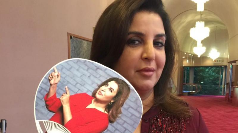 Farah Khan with customised hand-fan with her picture on it at the opening night of her film Om Shanti Oms play.