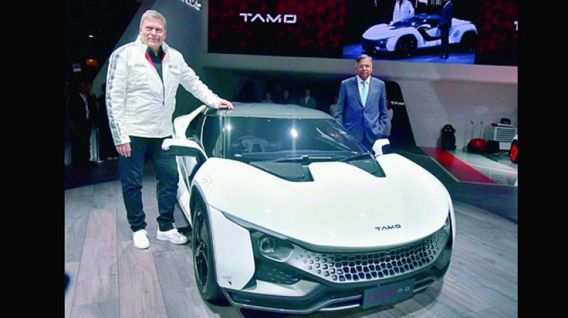 Tata Sons chairman N. Chandrasekaran, and Tata Motors CEO & MD Guenter Butschek pose with TAMO Racemo, showcased at the 87th Geneva International Motor Show in Switzerland on Tuesday. The two-seater sports coupe is the first product under the companys new sub-brand TAMO. It is powered by a rear-mounted 1.2-litre petrol engine delivering 190 PS of power. (Photo: AP)