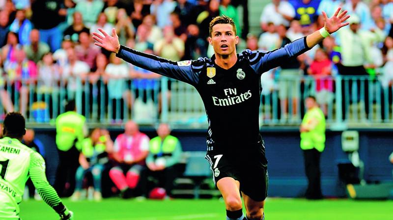 Cristiano Ronaldo celebrates his goal against Malaga (Photo: AP)