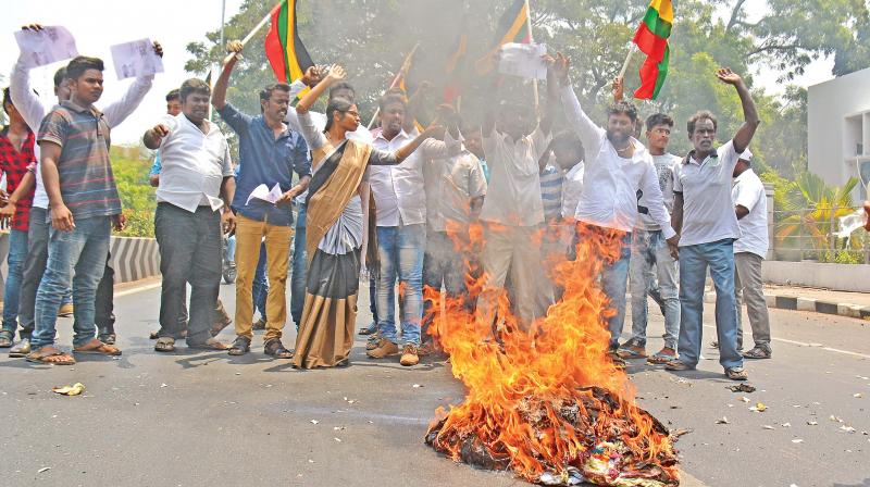 Members of the Tamizhar Munnetra Padai led by its president Veeralakshmi shout slogans and burn effigy of actor Rajinikanth on Cathedral road in the city on Monday (Photo: DC)