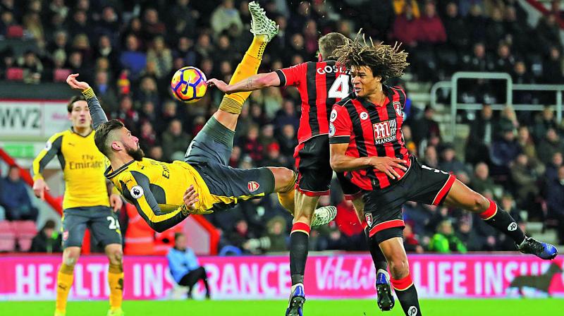 Arsenals Olivier Giroud (left) in action against FC Bournemouth in their English Premier League match at the Vitality Stadium in Bournemouth on Tuesday. The match ended 3-3. (Photo: AP)