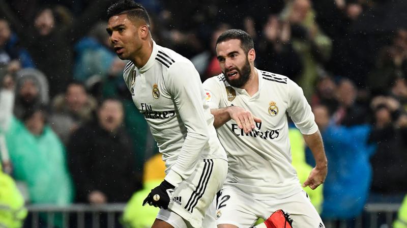 Casemiro celebrates with Dani Carvajal after scoring a goal during the match between Real Madrid and Sevilla. (Photo: AFP)