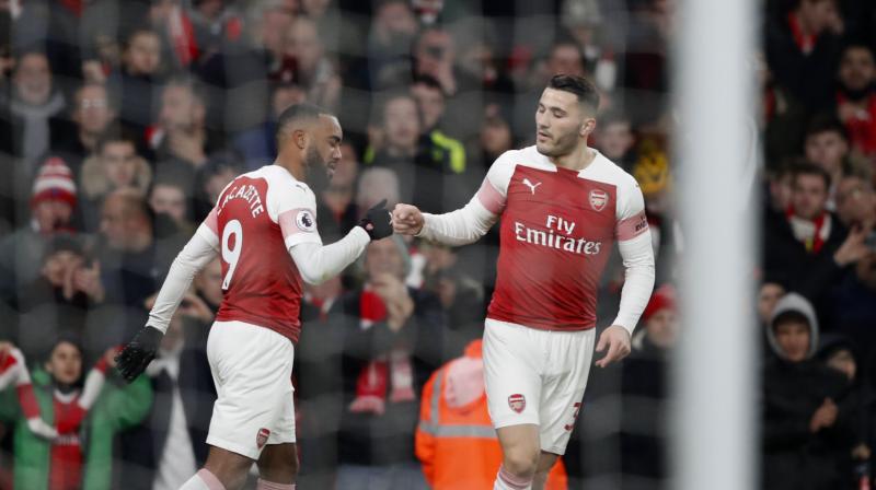 Lacazette celebrates with Kolasinac after scoring the opening goal during the match between Arsenal and Chelsea. (Photo: AP)