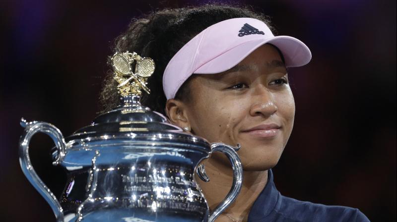 Naomi Osaka holds her trophy after defeating Petra Kvitova during the womens singles final at the Australian Open. (Photo: AP)