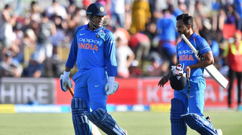 Dhoni and Jadhav walk from the field at the end of the Indian innings during the second ODI between New Zealand and India. (Photo: AFP)