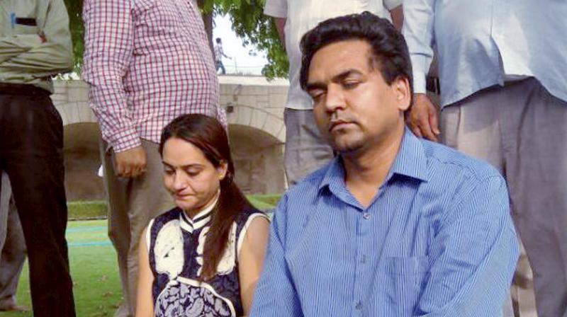 Sacked AAP MLA Kapil Mishra with his wife during his visit at Rajghat as he continues his hunger strike in New Delhi. (Photo: PTI)