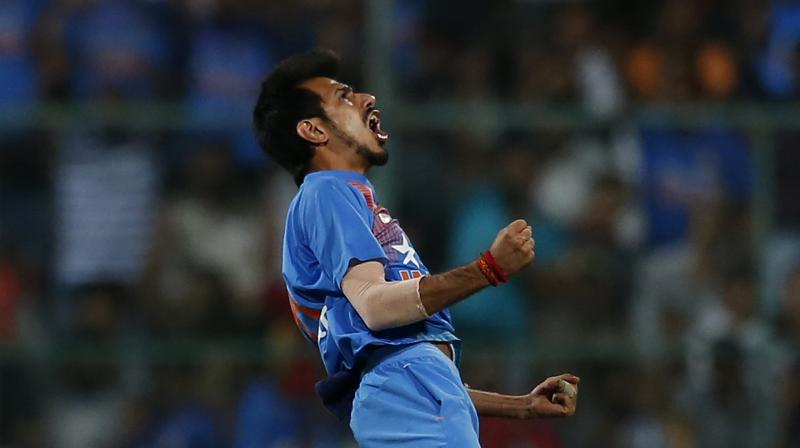 Indias Yuzvendra Chahal celebrates the wicket of Joe Root during the 3rd T20 between India and England at Chinnaswamy Stadium in Bengaluru on Wednesday (Photo: AP)