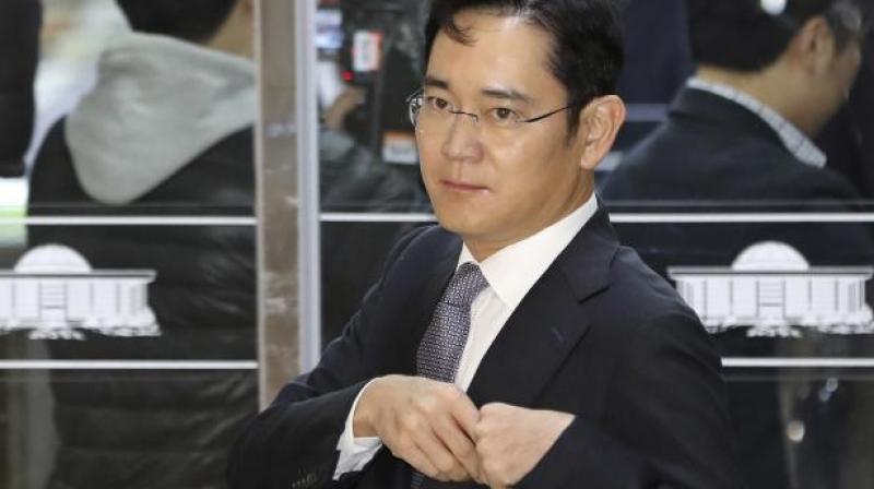 The vice-chairman of Samsung Electronics, 49, arrived at Seoul Central District Court on a justice ministry bus handcuffed (Photo: AP)