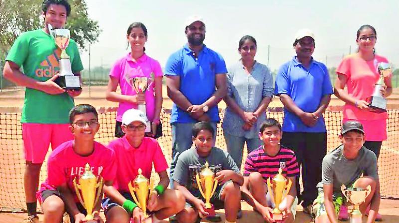 Winners and the runners-up of the AITA Championship Series All India Ranking tennis trophy pose with their trophies at the Vasishta Tennis Academy, Carnival Club in Sainikpuri, Secunderabad.