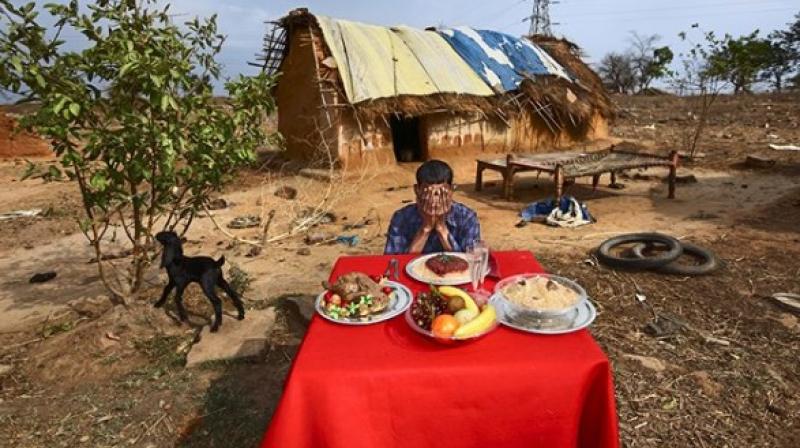 The photos, taken in villages of Uttar Pradesh and Madhya Pradesh, has a caption that reads, brought...a table and some fake food, and...told people to dream about some food that they would like to find on their table.  (Instagram Screengrab/ Worldpressphoto)