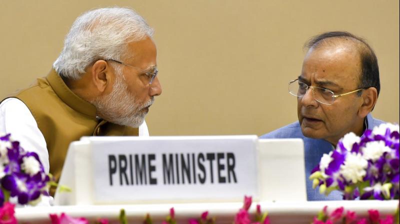 Prime Minister Narendra Modi talks with Finance Minister Arun Jaitley at a function to launch the MSME Support and Outreach Programme, in New Delhi. (Photo: PTI)