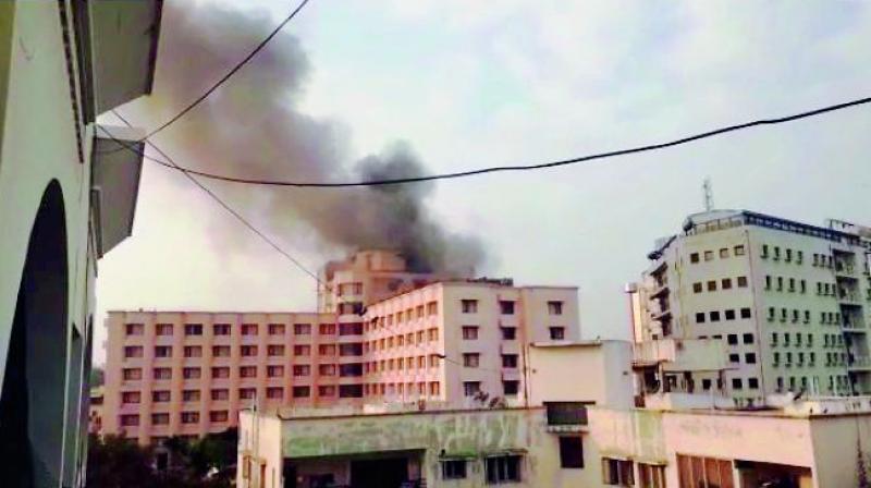 Smoke rises from Hotel Katriya on Tuesday morning. The fire was put out by fire services personnel by around 9 am. (Photo: DC)