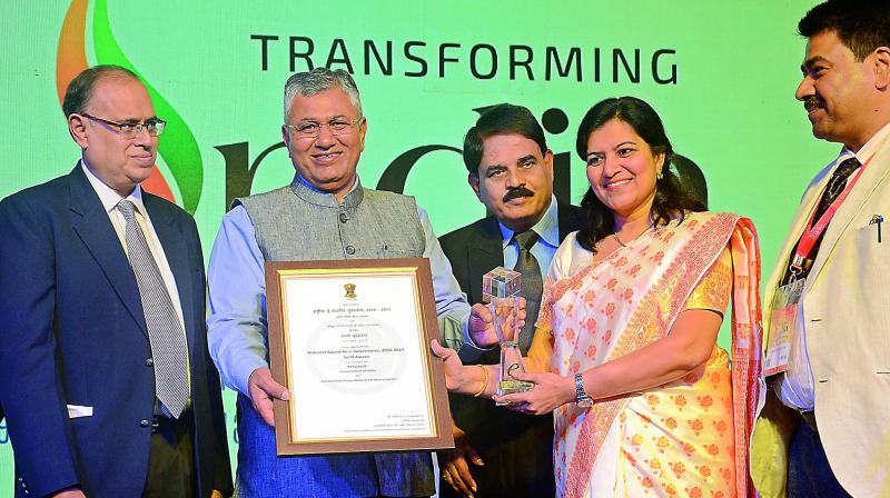 Minister of state for IT, P.P. Chaudhary, along with AP state IT minister Palle Raghunadha Reddy, presents the National e-Governance Award-2016-2017 under the category of incremental innovations in existing projects to the Union Joint Secretary, MGNREGA, Aparajita Sarangi, at the concluding ceremony of 20th National Conference on e-Governance at a hotel in Visakhapatnam on Tuesday. (Photo: DC)