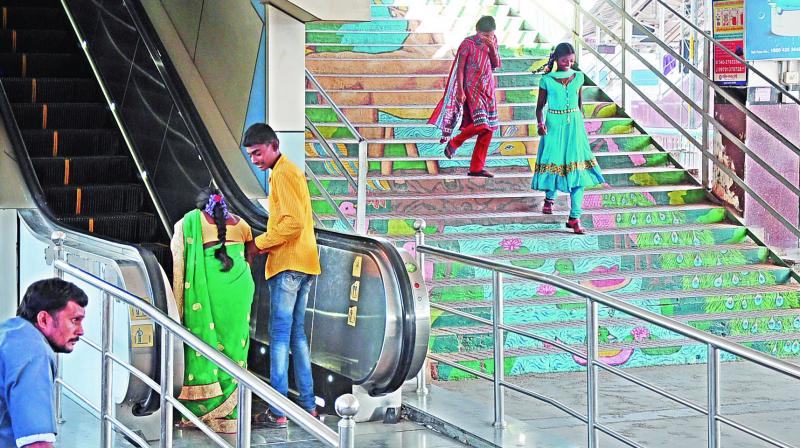 A man tries to help a woman take an escalator at the Kacheguda railway station on Wednesday. (Photo: DC)