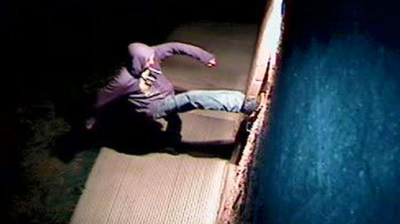 In this photo, still image from a video surveillance camera, a suspect is shown during the vandalizing of a mosque near Colorado State University in Fort Collins, Colorado. (Photo: AP)