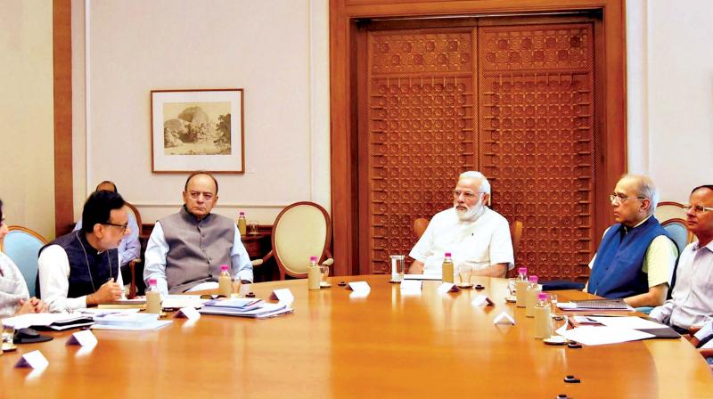 Prime Minister Narendra Modi reviewing the status of GST, which is to be implemented from July 1, in New Delhi on Monday. (Photo: PTI)
