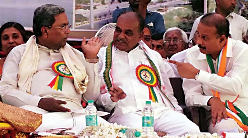 Former chief minister Siddaramaiah in conversation with minister Puttaranga Shetty and MP R. Dhruvanarayana at a function to release a booklet of Dhruvanarayanas achievements in Chamarajanagar on Saturday