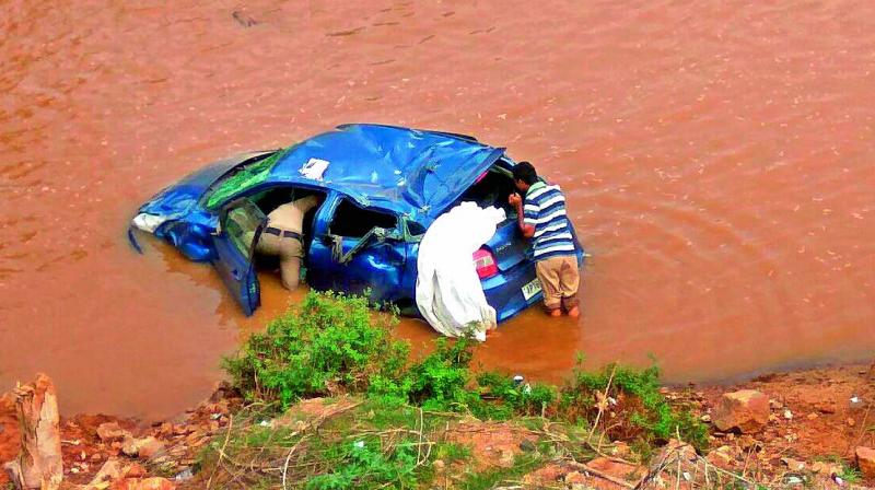 Mangled remains of a car which plunged into a canal at Polavaram on Wednesday.
