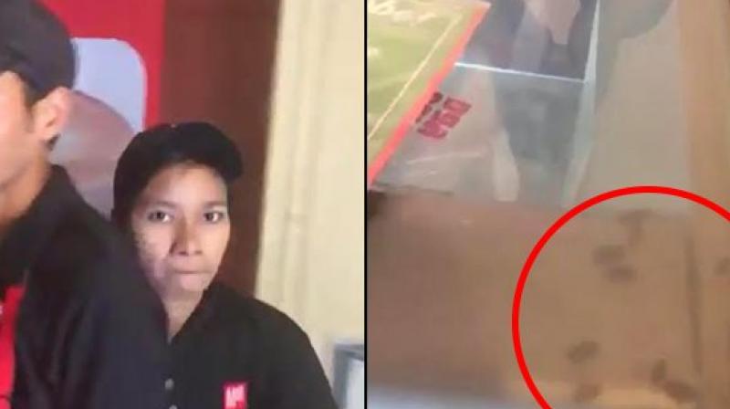 The video shows several cockroaches running inside the refrigerator counter before a lady server gives the customer a tight slap. (Credit: Twitter)