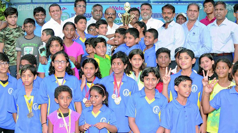 Overall championship runners-up Hyderabad team pose with the trophy in the 3rd Telangana State Sub-Junior and Junior Inter-District Swimming Championship.