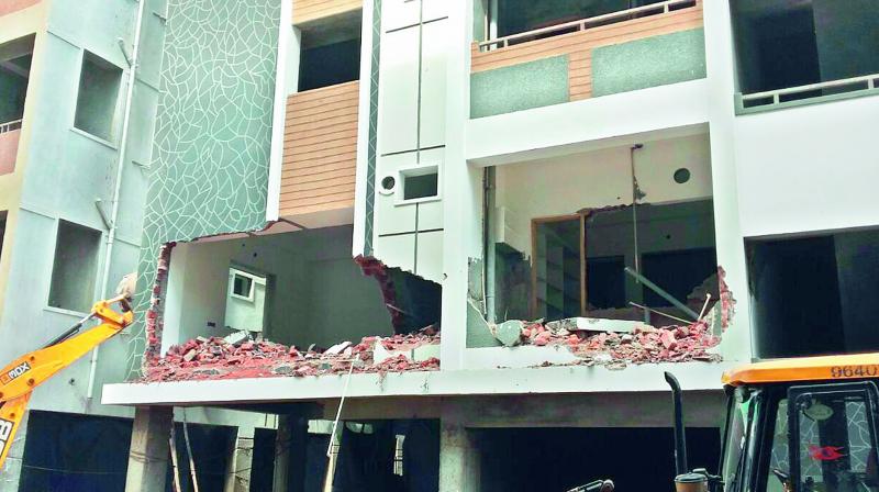 HMDA razes illegal structures in Bhandari Layout in Nizampet on Tuesday.