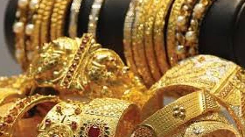 Gold for delivery in far-month June was trading lower by Rs 127, or 0.43 per cent, to Rs 29,299 per 10 gram