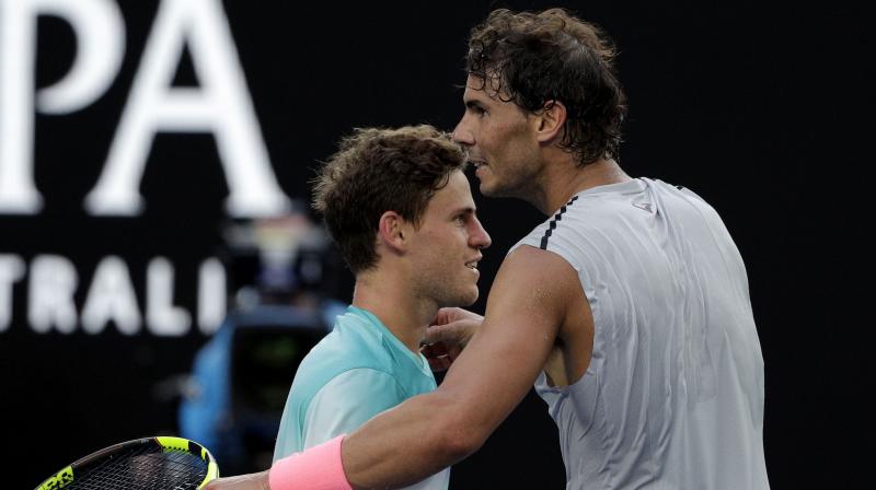 After embracing at the net, his spot in a 10th Australian Open quarterfinal secure, top-ranked, Rafael Nadal draped an arm around his Argentine friend and patted him on top of the head.(Photo: AP)
