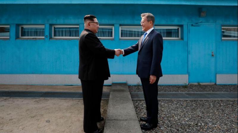 North Koreas leader Kim Jong Un (L) shaking hands with South Koreas President Moon Jae-in (R) at the Military Demarcation Line that divides their countries ahead of their summit at the truce village of Panmunjom. (Photo: AFP)