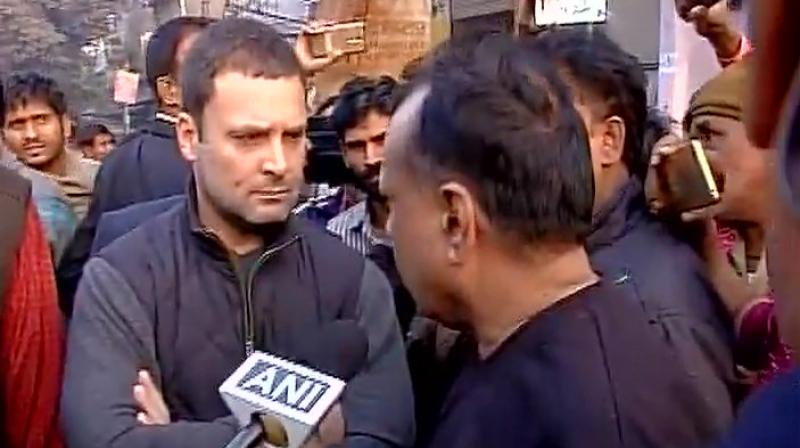 Congress Vice President Rahul Gandhi interacts with people outside ATM in Delhis Anand Parbat area. (Photo: ANI Twitter)