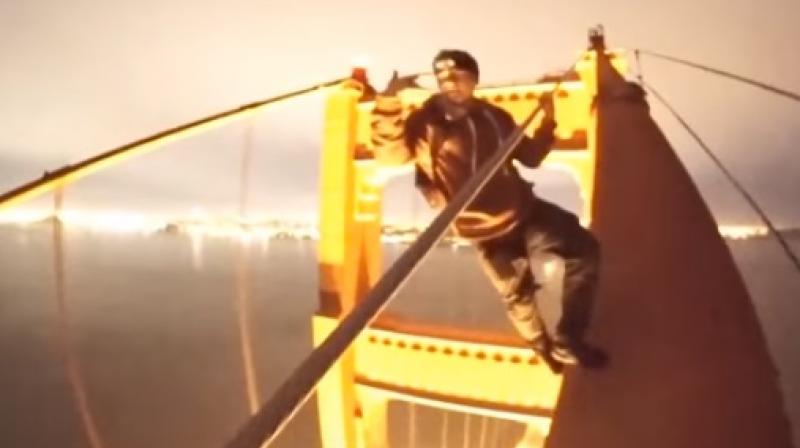 The daredevil boys climbed the 746-foot bridge without any fear and performed several stunts and even took a selfie while walking upwards. (Photo: Youtube)