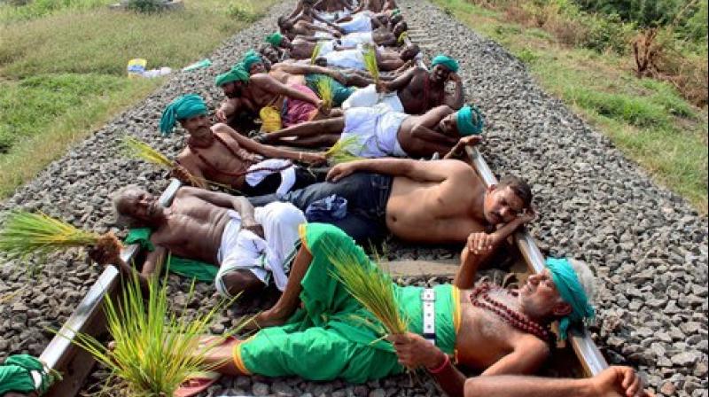 Farmers and opposition parties members staging a rail roko agitation at Trichy. (Photo: PTI)