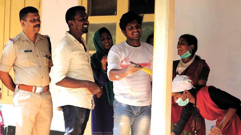 NSS volunteers during cleaning drive held at Government Dermatology Hospital, Chevayoor on Sunday. Medical College circle inspector Moosa Vallikkadan looks on. (Photo: Akhin Dev)