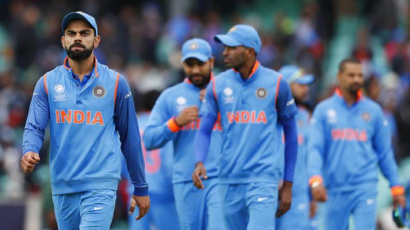 Indias captain Virat Kohli, left, leads his team off the pitch (Photo: AP)