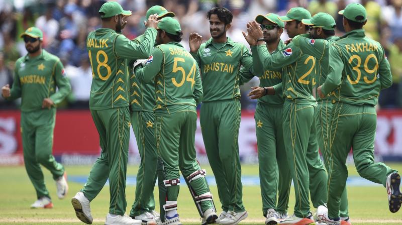 Pakistans Hasan Ali , centre, celebrates the wicket of Englands Eoin Morgan with his teammates during the ICC Champions Trophy, semifinal cricket match between England and Pakistan in Cardiff. (Photo: AP)