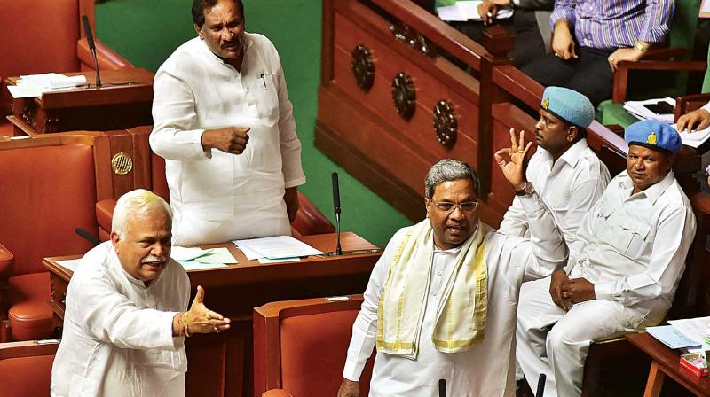 CM Siddaramaiah and ministers R.V. Deshpande and K.J. George during the Assembly session in Bengaluru on Tuesday. (Photo: KPN)