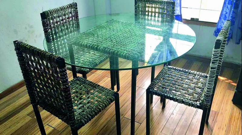 Handwoven: Work on the dinning table and chairs made of discarded chips packets was started seven to eight months ago. Right, another creation. (Photo: DC)