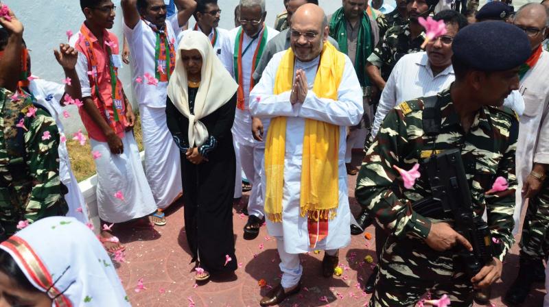 BJP national president Amit Shah being welcomed at Kavaratti in Lakshadweep on Tuesday. Lakshawdeep BJP president C. Abdul Khader is also seen. (Photo: DC)