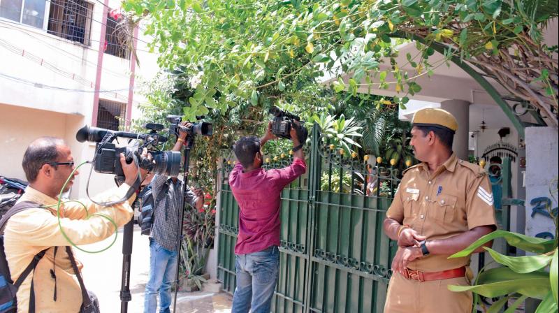 Media persons take video outside the residence of DGP T.K. Rajendran.    (Image: DC)