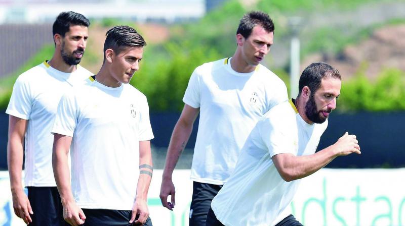 Juventus Sam Kedhira (from left), Paulo Dybala, Mario Mandzukic and Gonzalo Higuain at a training session on Tuesday, ahead of their Champions League quarterfinal second leg match against Barcelona at the Vinovo Sport Center near Turin, Italy. (Photo: AP)