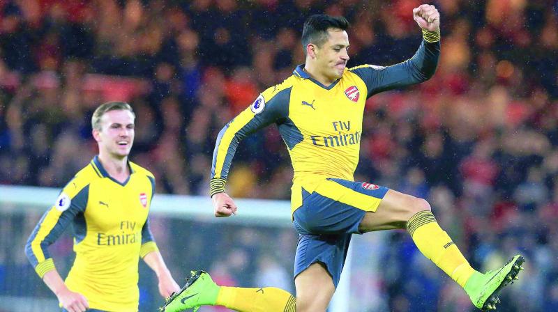 Arsenals Alexis Sanchez (right) celebrates his goal in their Premier League match against Middlesbrough at the Riverside Stadium on Monday. Arsenal won 2-1. (Photo: AFP)