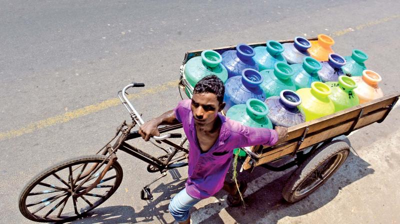 With drinking water availability getting worse, a man pulls his tricycle with water pots at Egmore on Tuesday. (Phoot: DC)