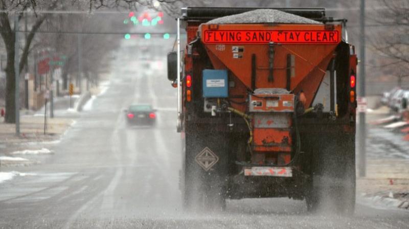 This photo shows a city truck is spreading salt on Q Street in Lincoln, Neb. Scientists are starting to raise concerns about road salts impact on the environment, especially drinking water, because lakes and streams near roads are showing elevated levels of sodium and chloride. (Photo: AP)