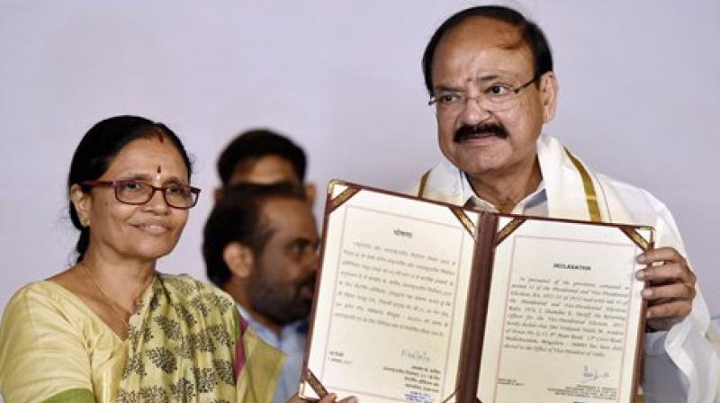 Vice-president elect Venkaiah Naidu with wife Usha shows victory certificate after being elected as the Vice President of India, in New Delhi on Saturday. (Photo: PTI)